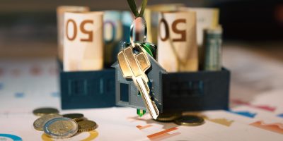 pexels photo 30139610 30139610 Keys hanging with money and charts, symbolizing real estate investment and financial planning.